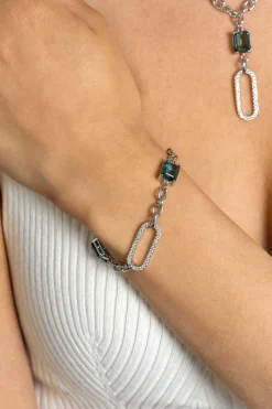 ZINZI zilveren fantasie schakel armband met ovale schakel, bezet met witte zirconia's en twee groenachtig blauwe (petrol) kleurstenen in vierpootszetting 18-21cm ZIA2487