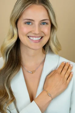 ZINZI zilveren schakelketting met twee verbonden ovale schakels: één gold plated, de ander bezet met witte zirkonia's 42-45cm ZIC2758